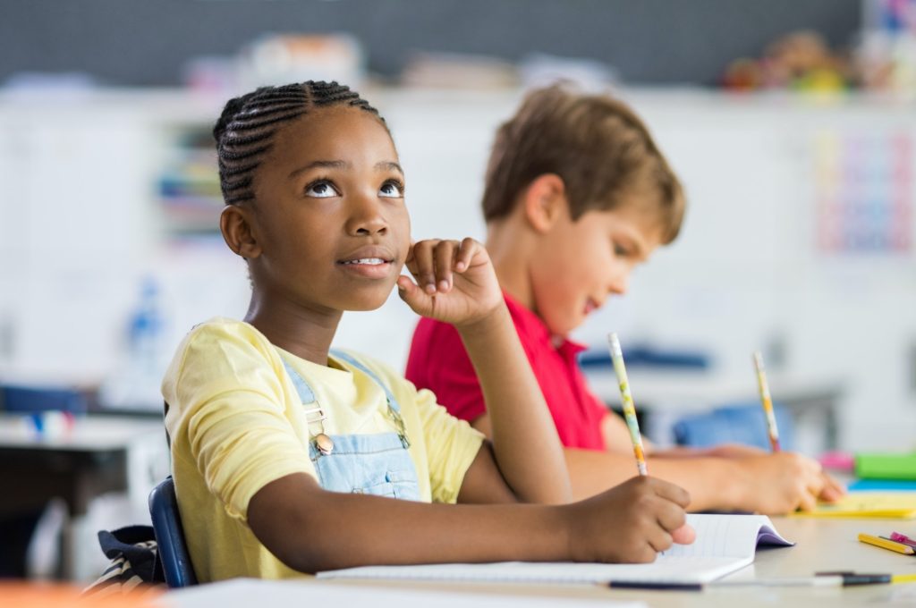 African girl thinking in class